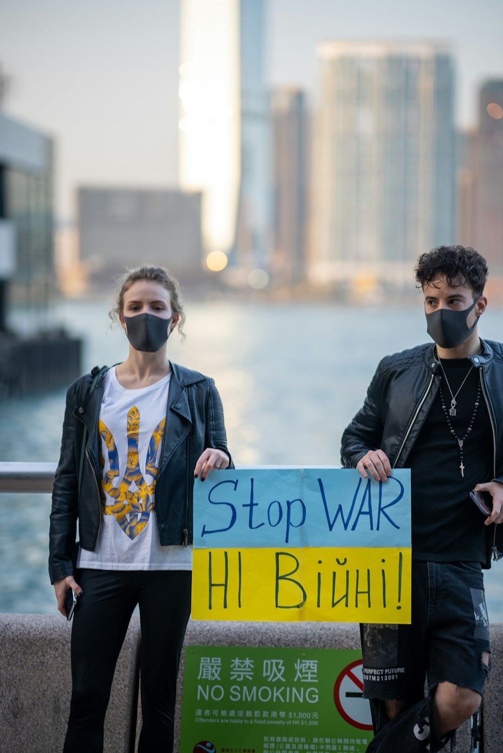 a man and a woman standing next to each other holding a sign