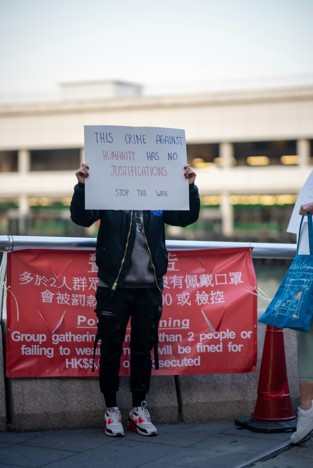 a man holding up a sign in front of him