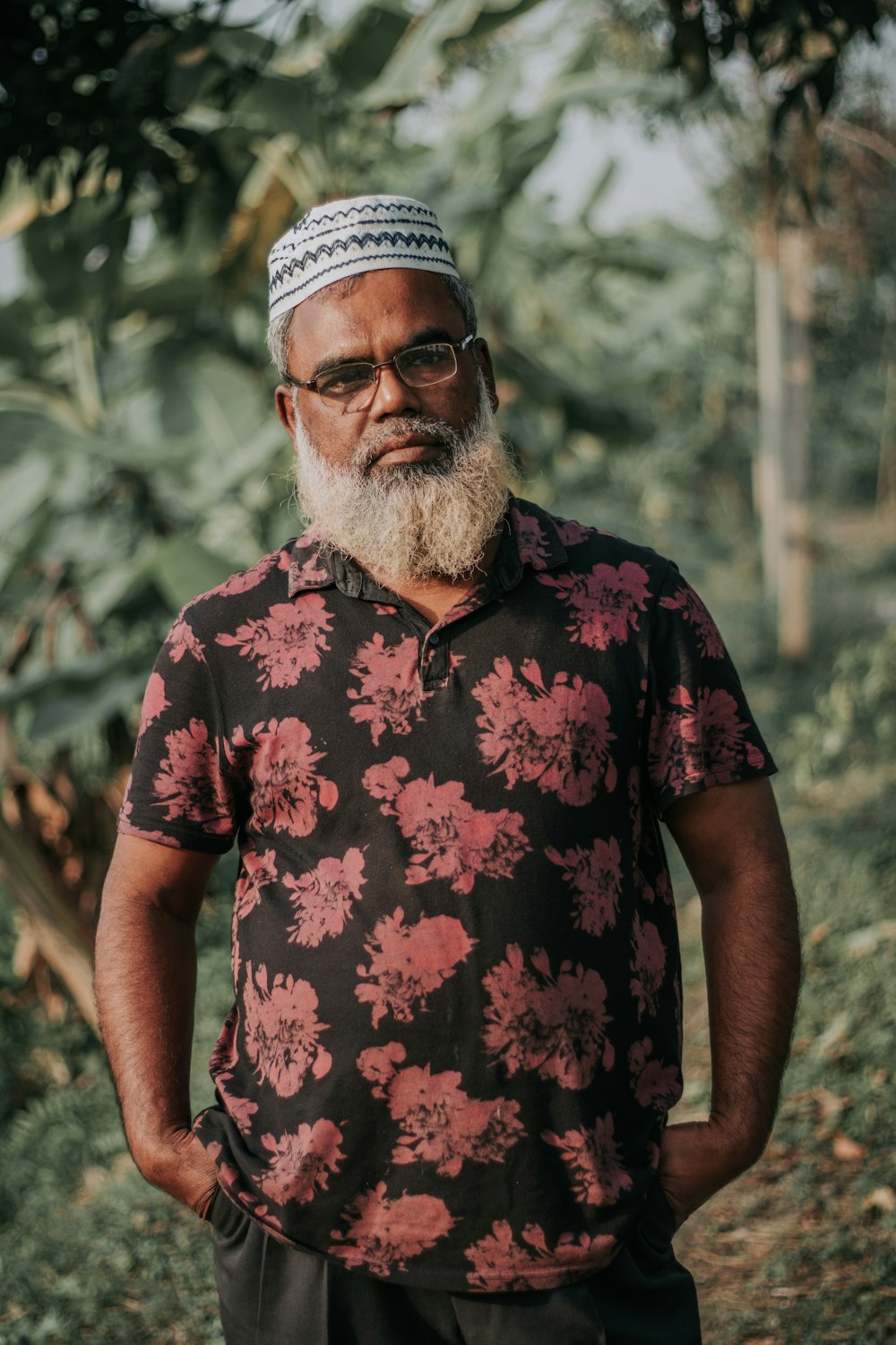 a man with a white beard wearing a floral shirt