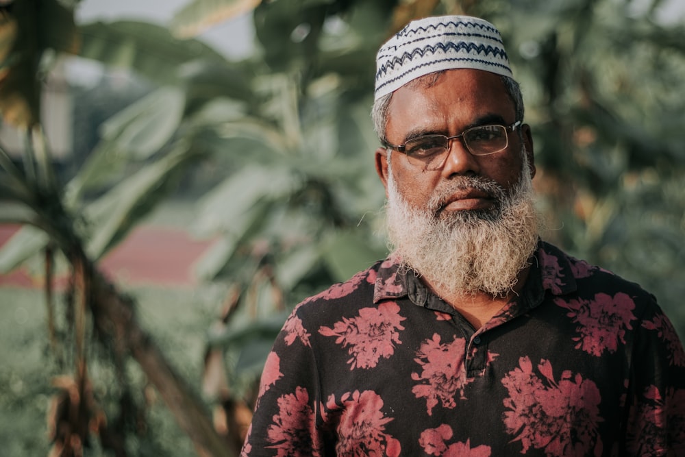 a man with a white beard wearing a floral shirt