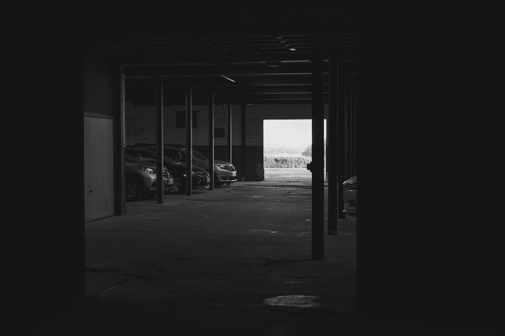 an empty parking garage with cars parked in it