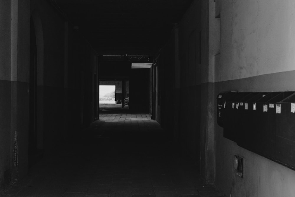 a dark hallway with multiple pictures on the wall