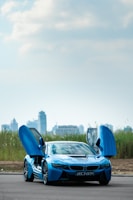 a blue sports car parked on the side of the road