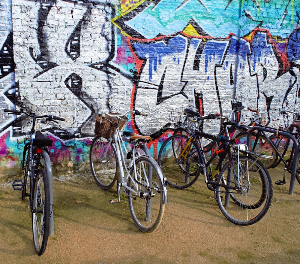 a bunch of bikes are parked in front of a wall