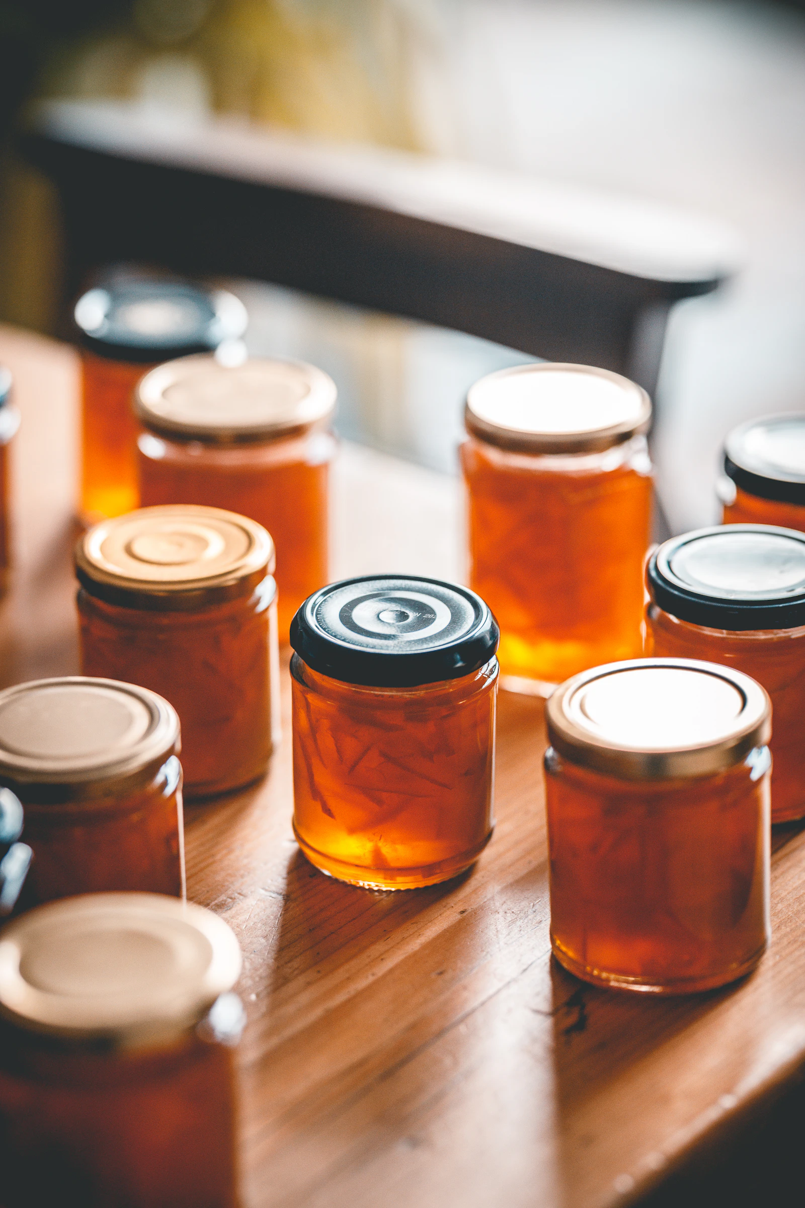 Several jars of honey sit on a table