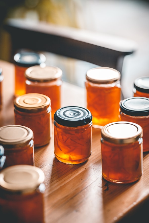 Jars of homemade honey lined up on a table