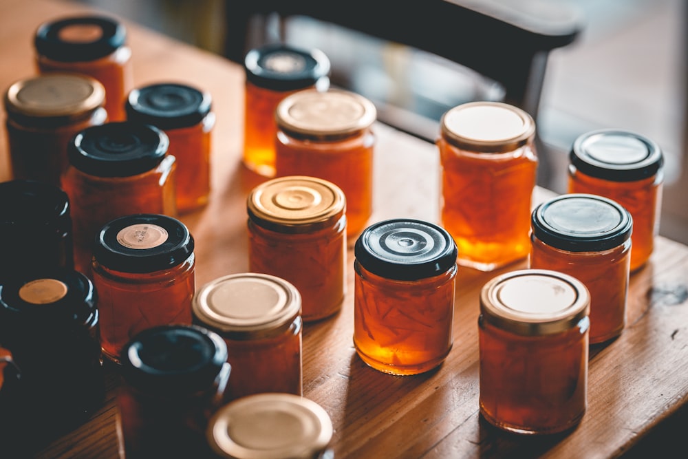 a table topped with lots of jars filled with liquid