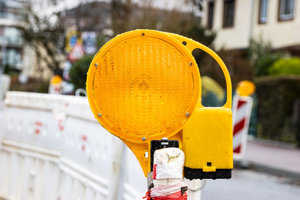 a yellow traffic light sitting on the side of a road