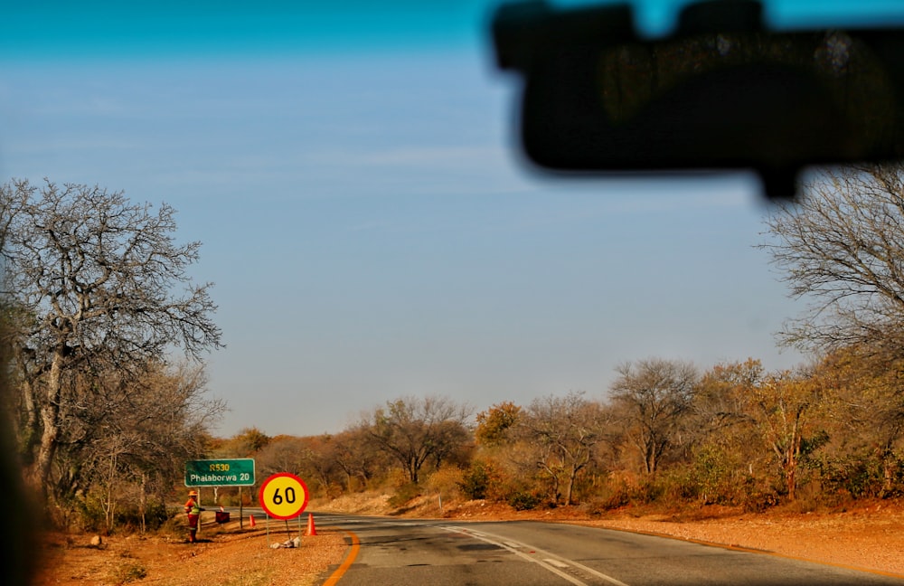 a view of a street sign from a car window