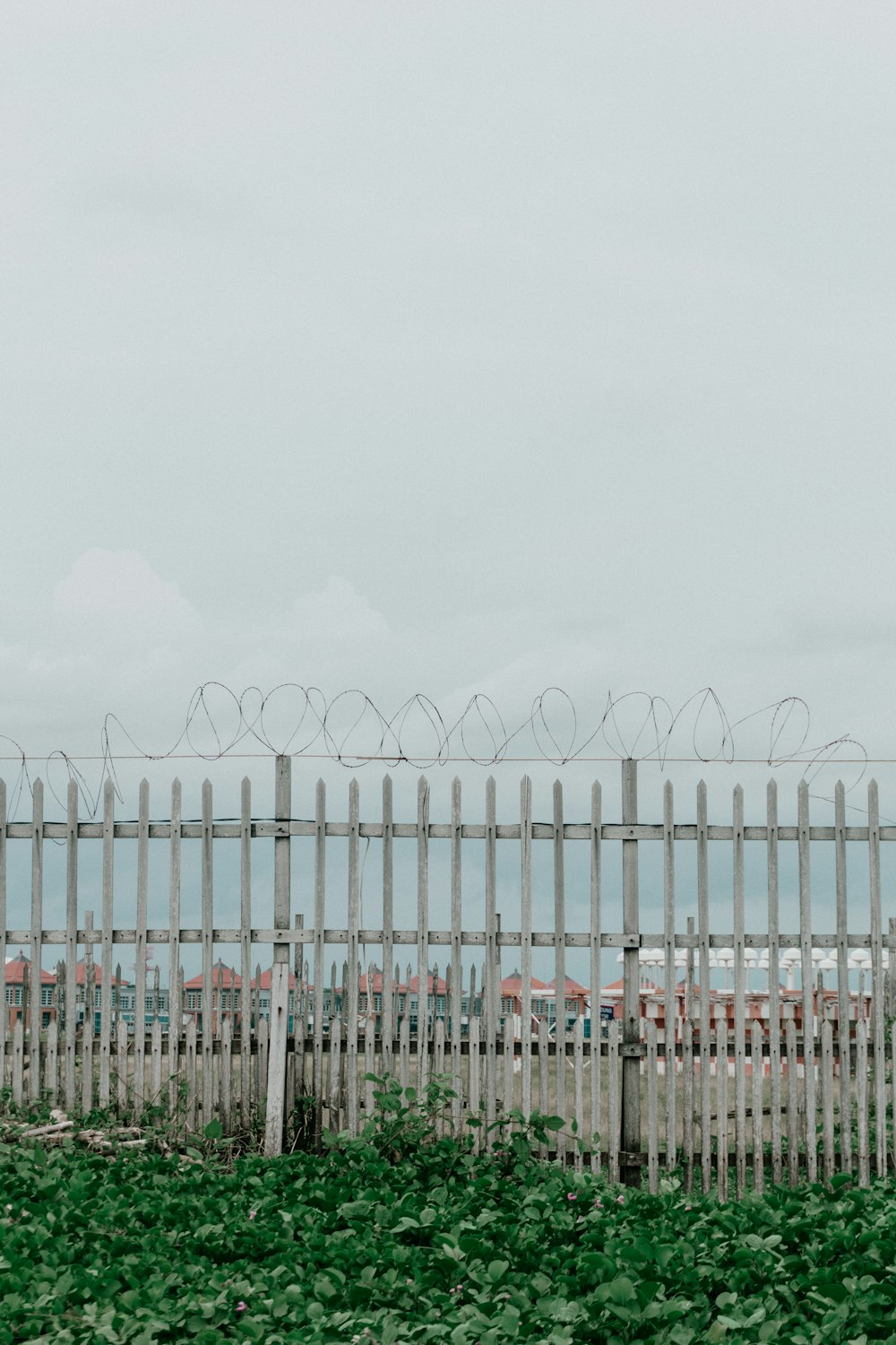 a fence with a bunch of barbed wire on top of it