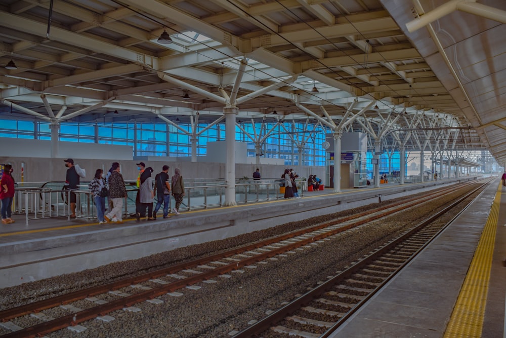 a group of people waiting at a train station