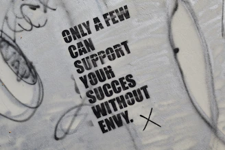 graffiti on the side of a wall that says only a few can support your success