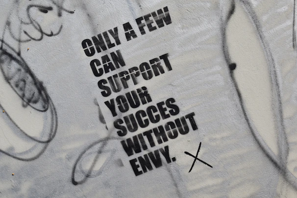 graffiti on the side of a wall that says only a few can support your success