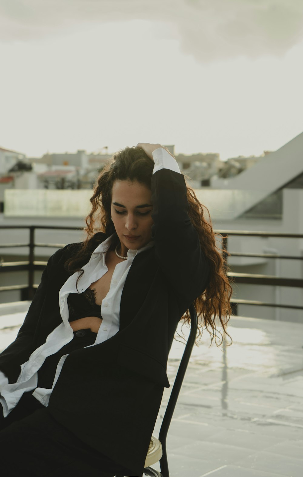 a woman sitting in a chair on top of a roof