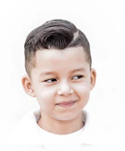 a young boy with a short haircut and a white shirt
