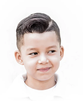 a young boy with a short haircut and a white shirt