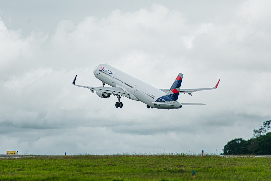 a large jetliner flying through a cloudy sky,