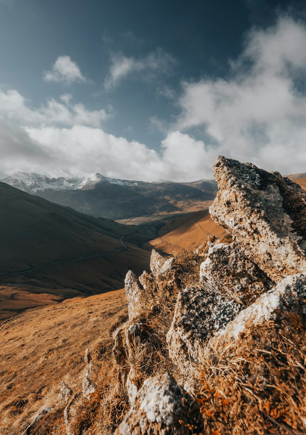 a rocky outcropping in the mountains under a cloudy sky