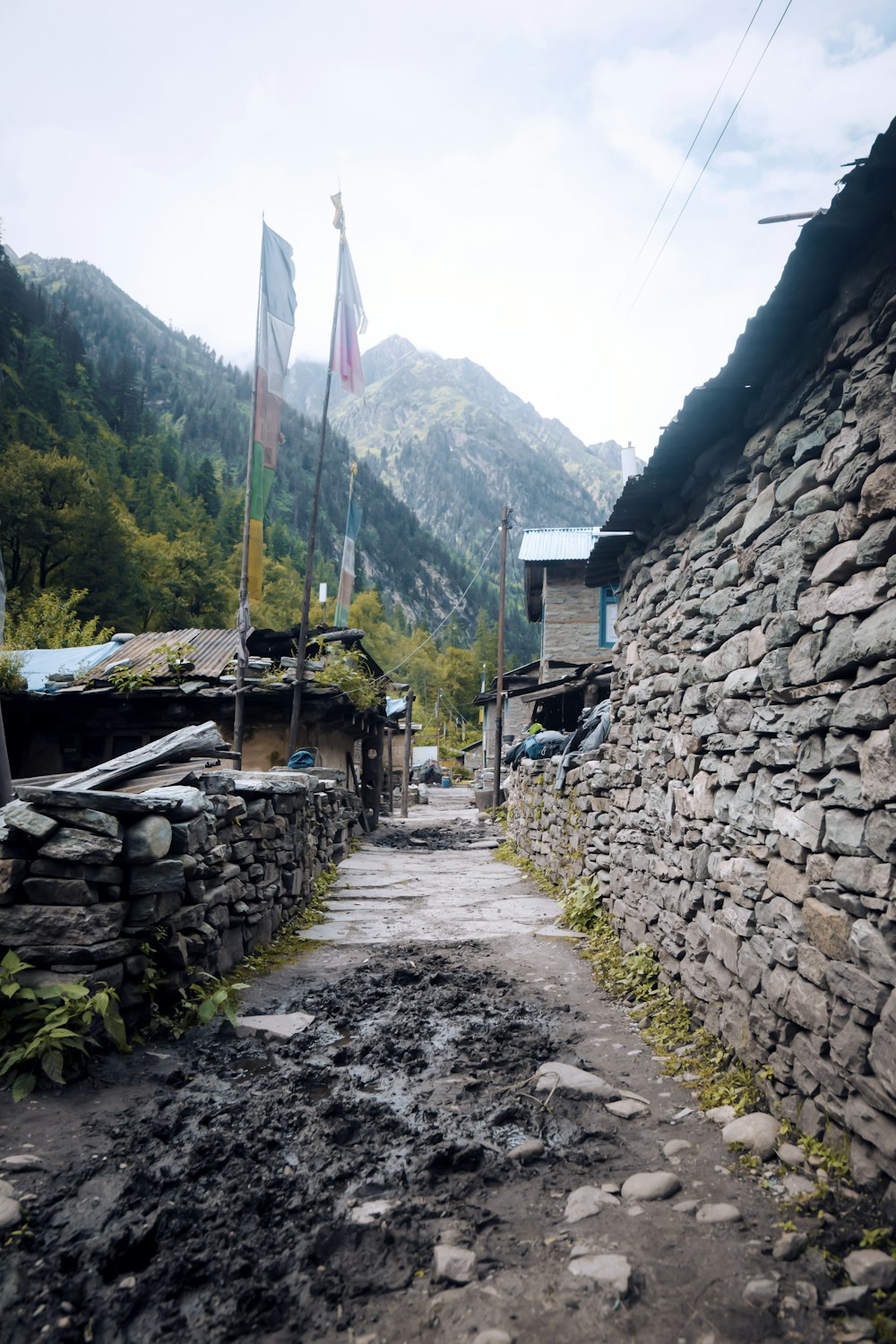 a stone wall with flags on top of it