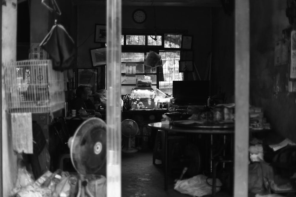 a black and white photo of a person in a room