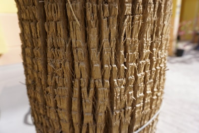 Close-up of natural jute fibers bundled neatly on a wooden table.