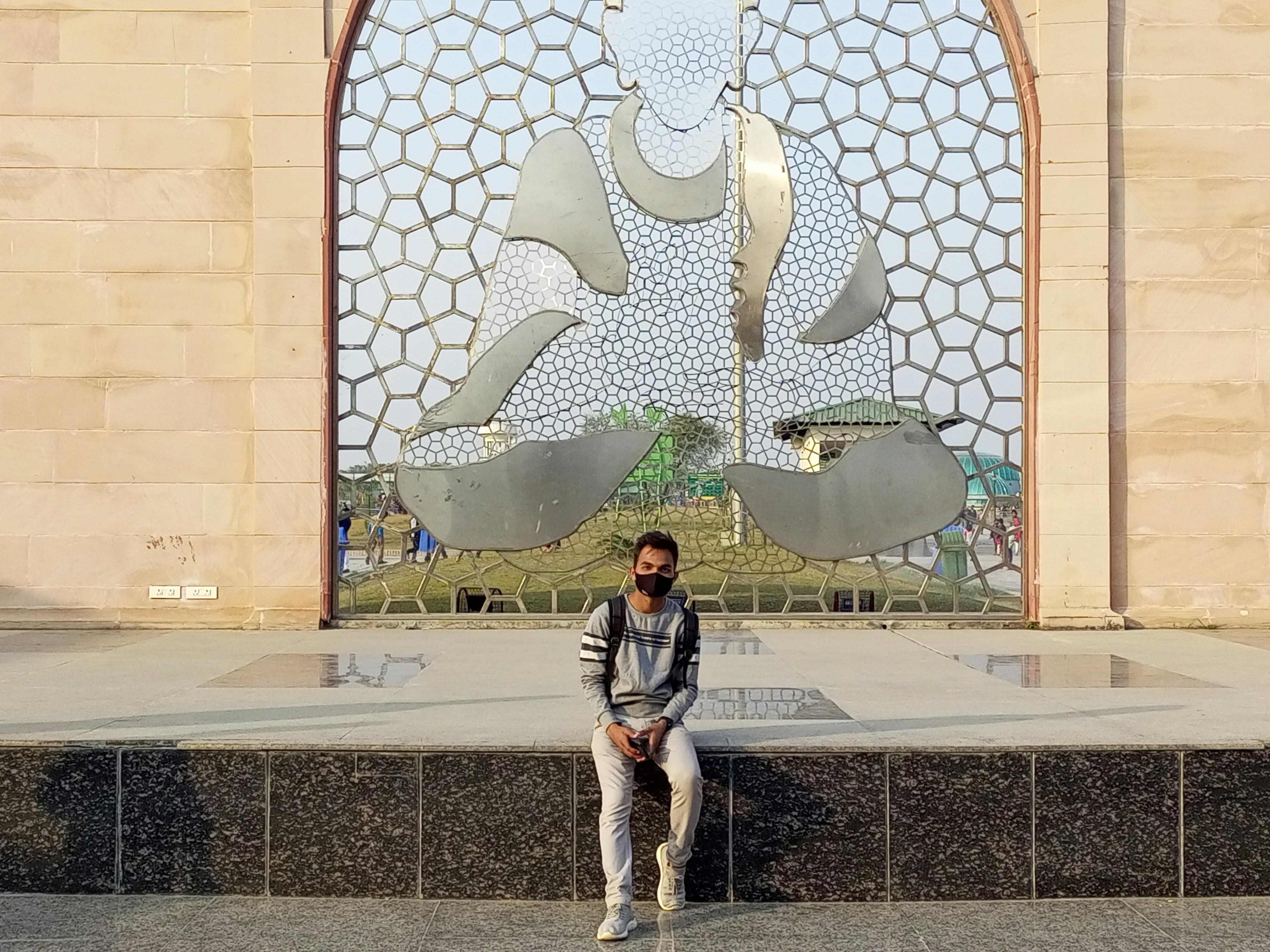 a man sitting on a bench in front of a building
