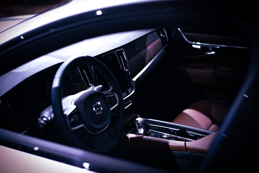 the interior of a car with a steering wheel and dashboard