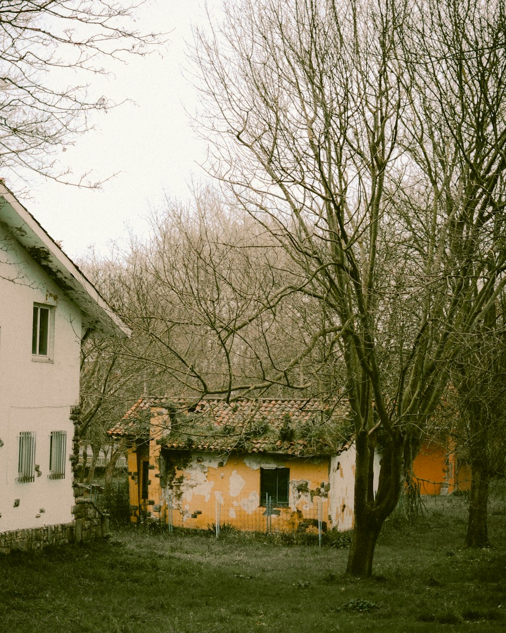 an old run down house in the middle of a field