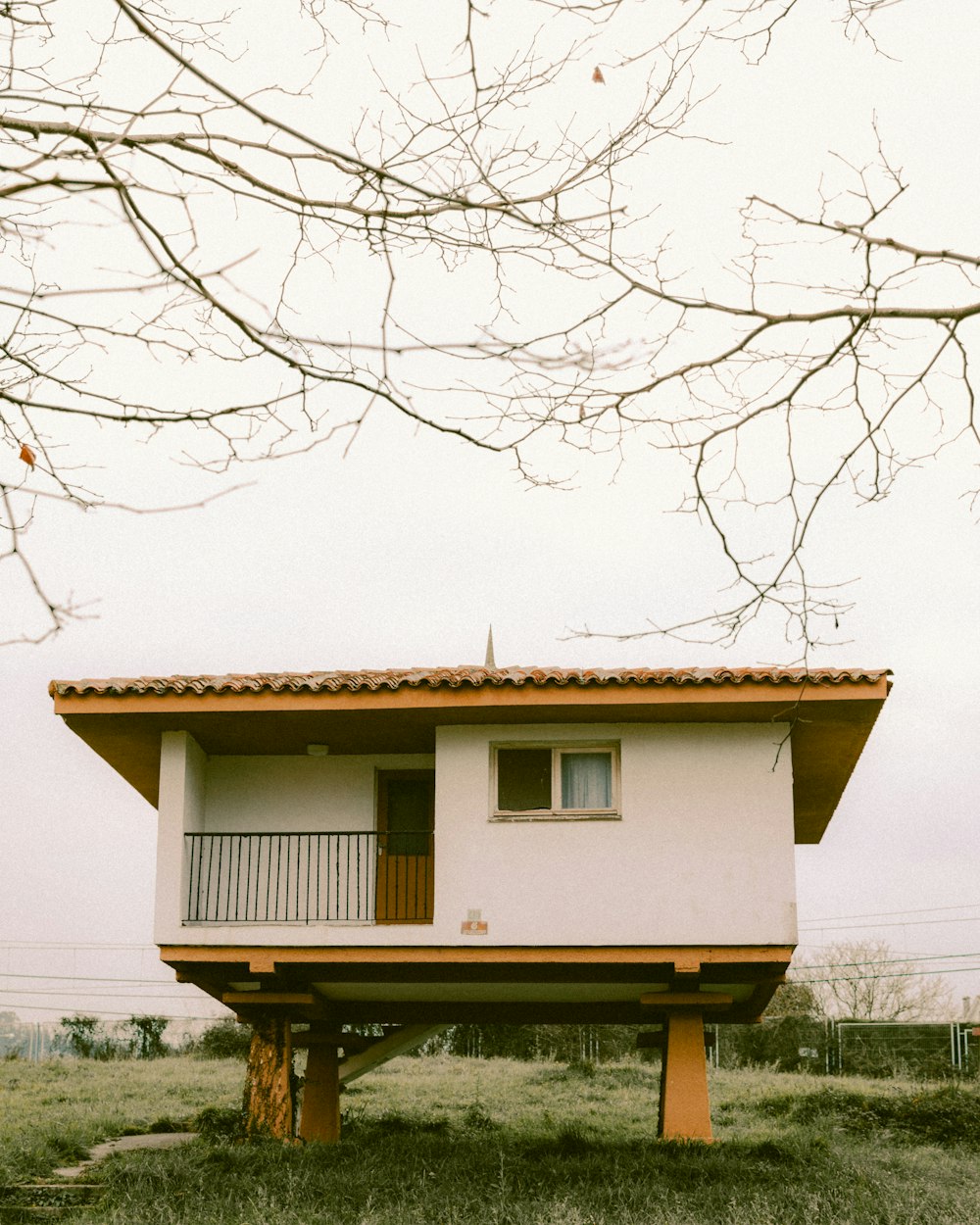 a small house sitting on top of a lush green field