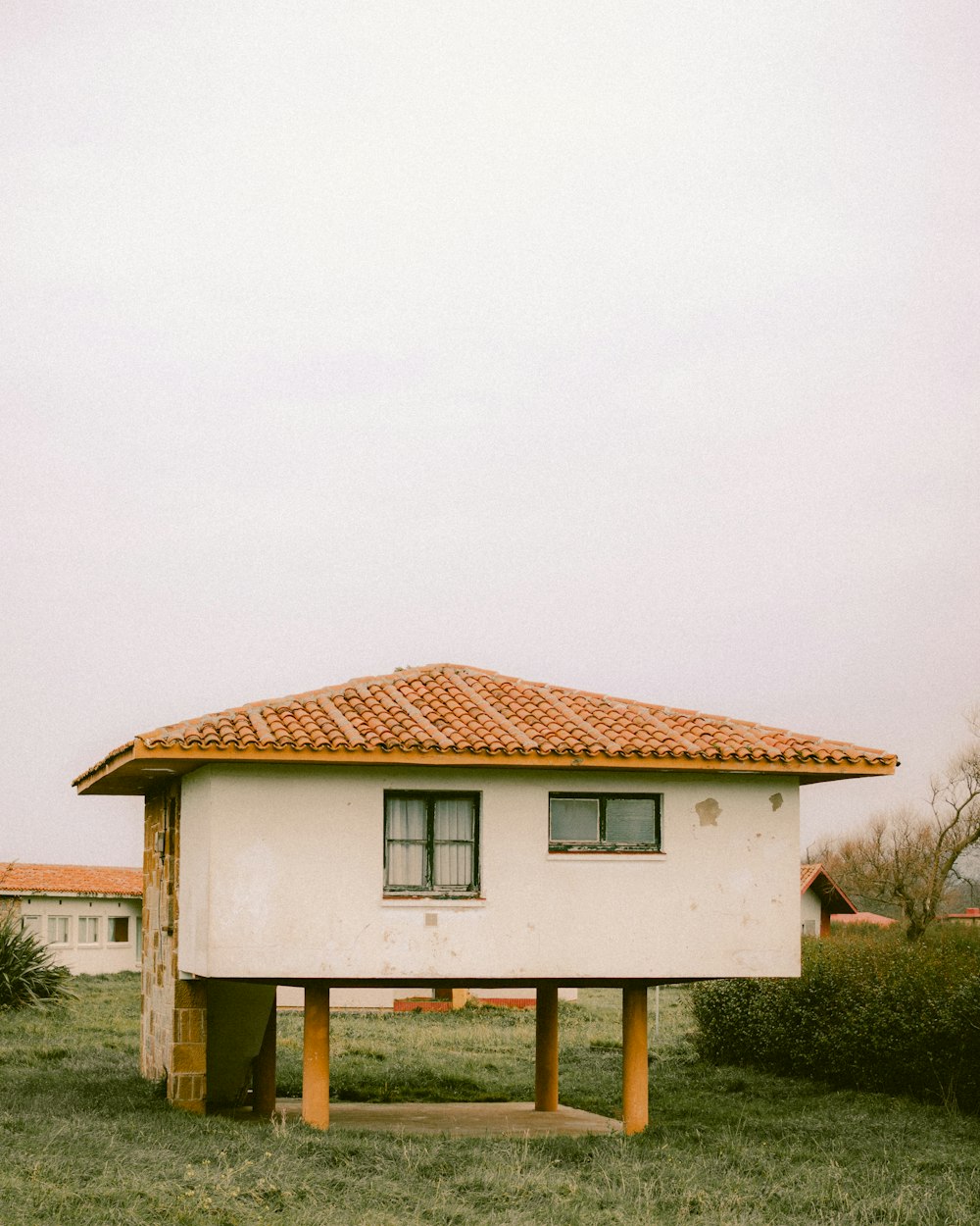 a white building with a red tiled roof