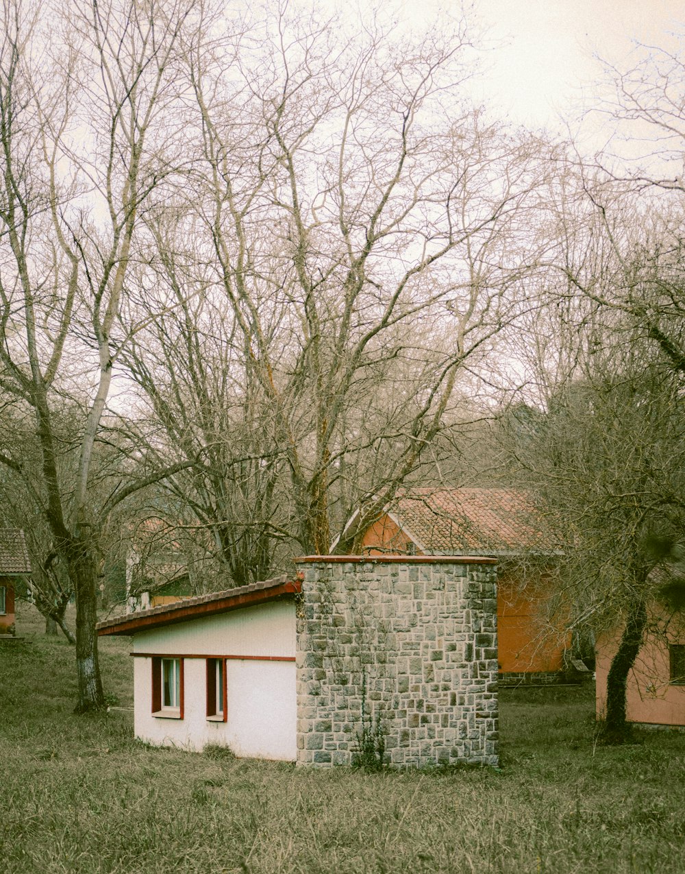 Un piccolo edificio di mattoni seduto nel mezzo di un campo