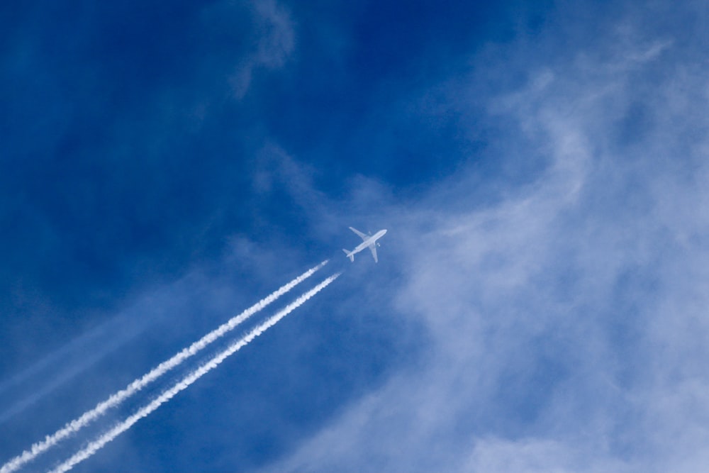 an airplane is flying in the blue sky