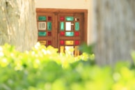 A detailed shot of colorful stained glass panels set into an arched wooden door.