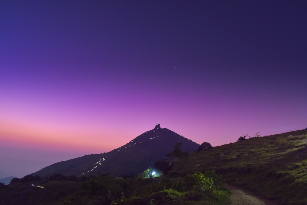 a mountain with a trail going up it at night