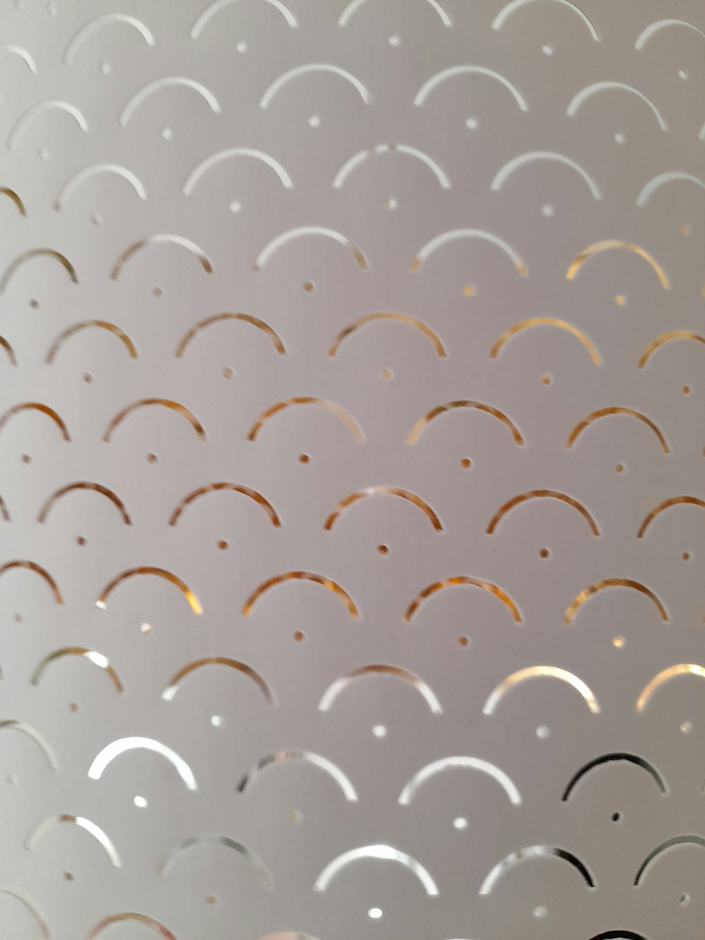 a close up of a metal surface with circles