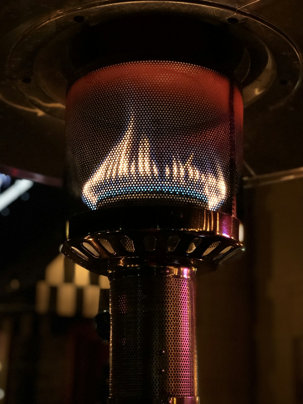 a close up of a metal object with a flame