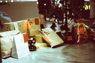 a table topped with bags and a christmas tree