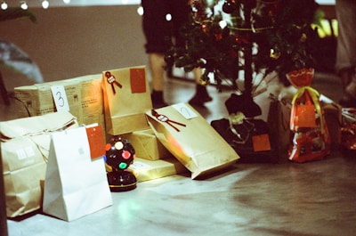 a table topped with bags and a christmas tree