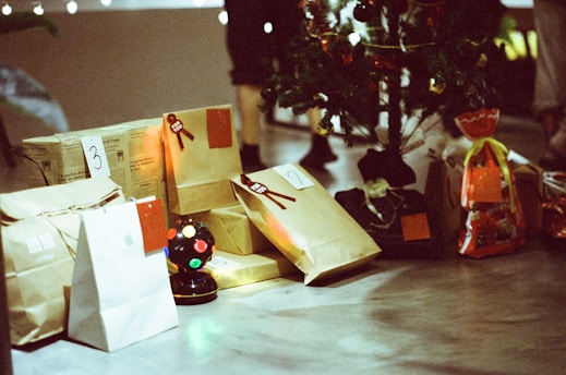 a table topped with bags and a christmas tree