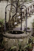 The village’s historic well surrounded by blooming marigolds and stone steps.