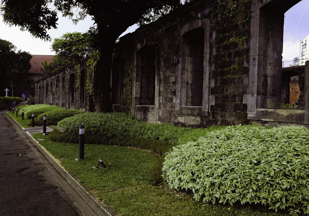 a stone building with a grassy area next to it