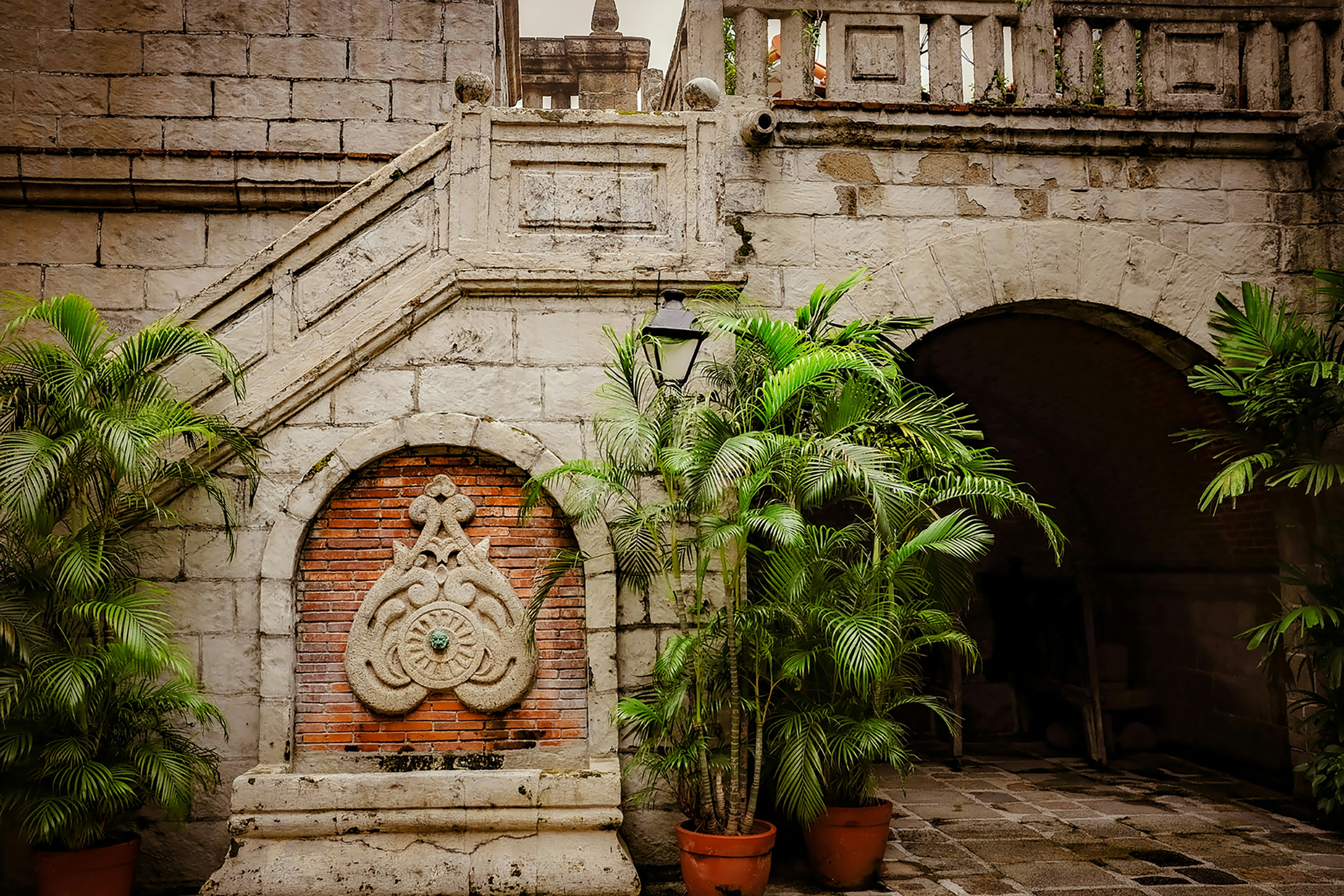 a stone building with a planter in front of it