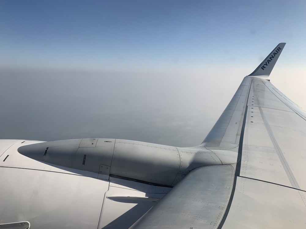 a view of the wing of an airplane in the sky