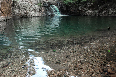 a body of water with a waterfall in the background