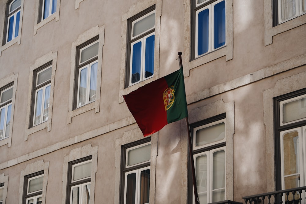 a flag flying in front of a building