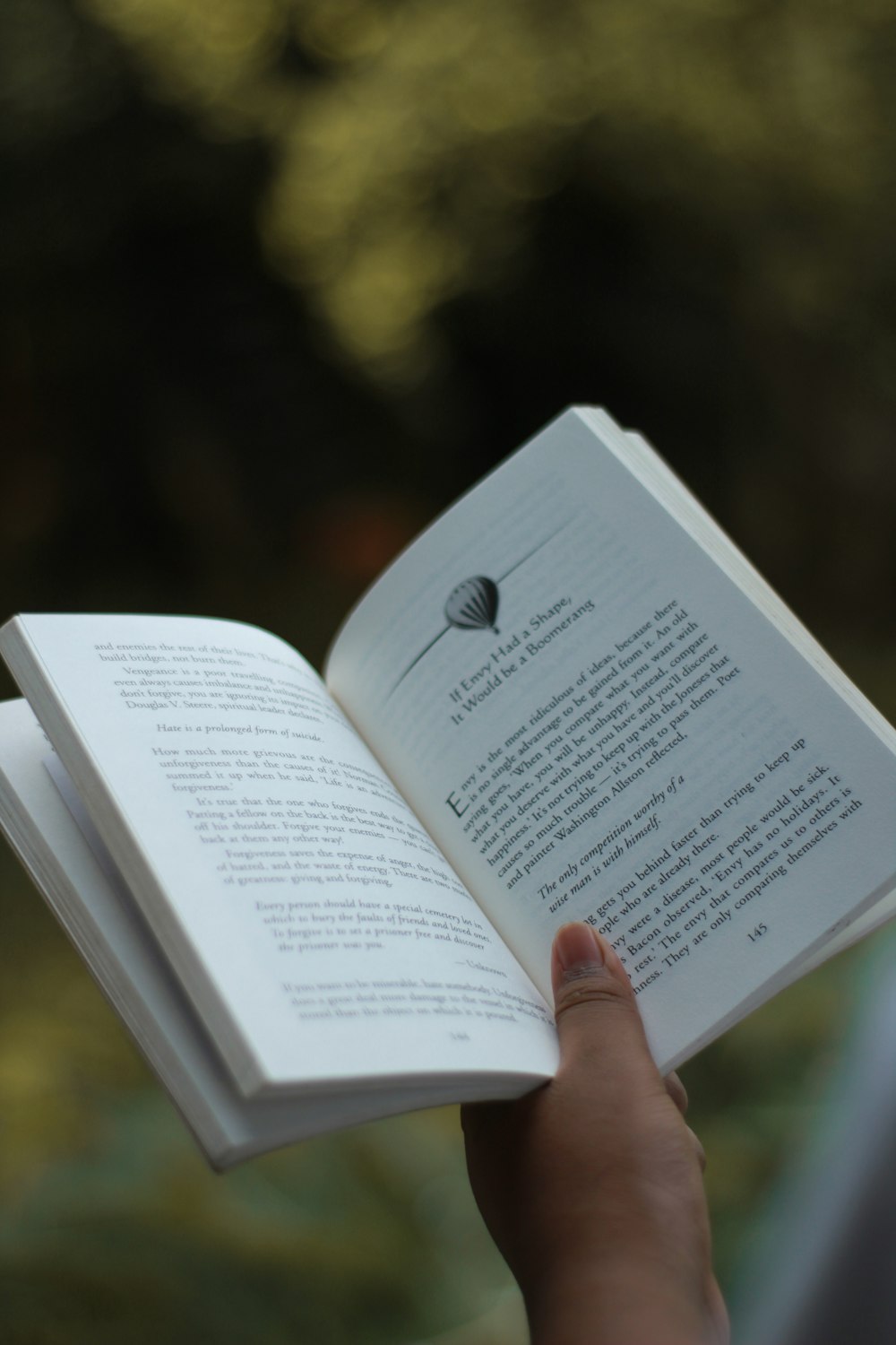 a person holding a book in their hand