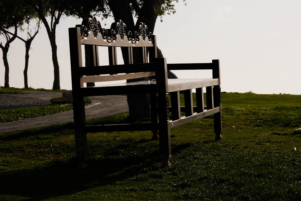 a wooden bench sitting on top of a lush green field