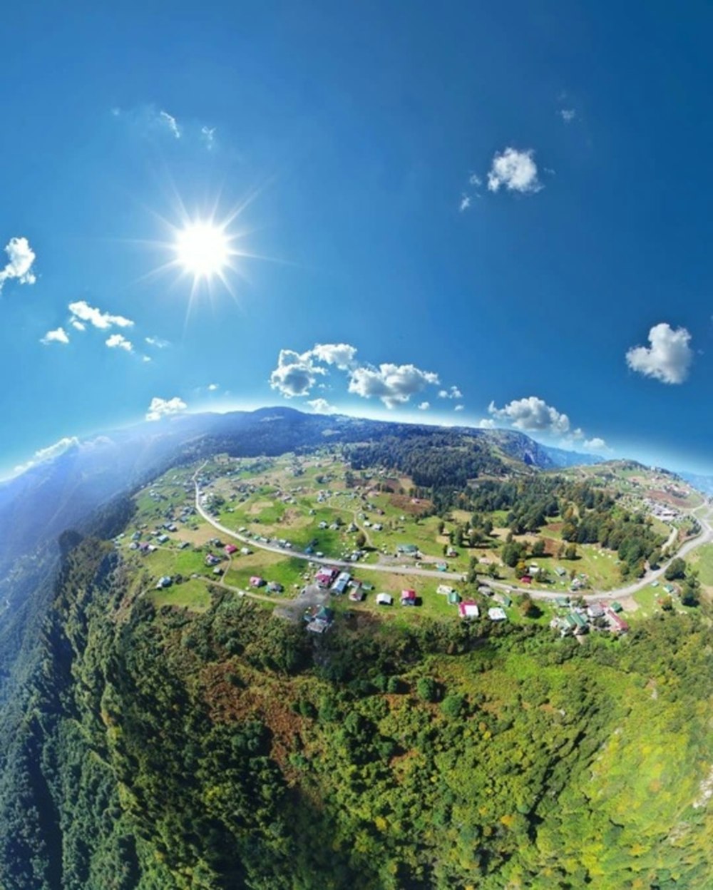 an aerial view of a small town on a hill