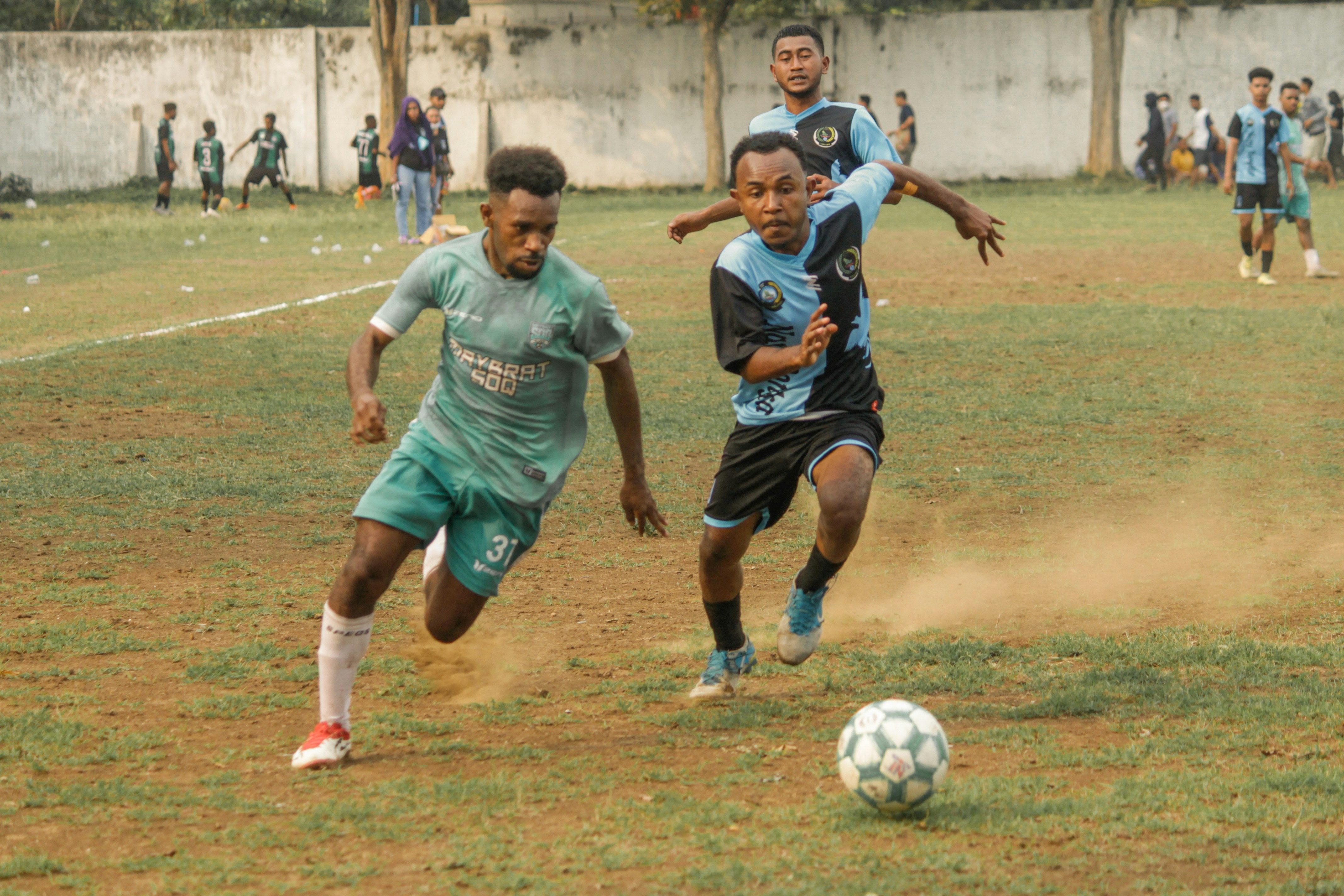 a group of young men playing a game of soccer