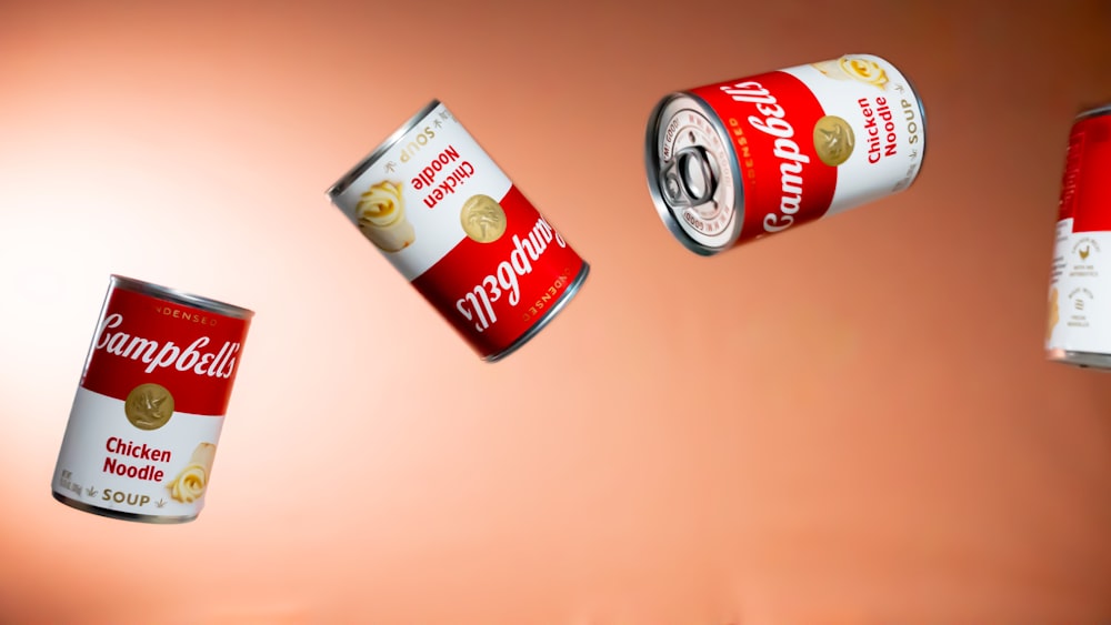 a group of cans of food flying through the air